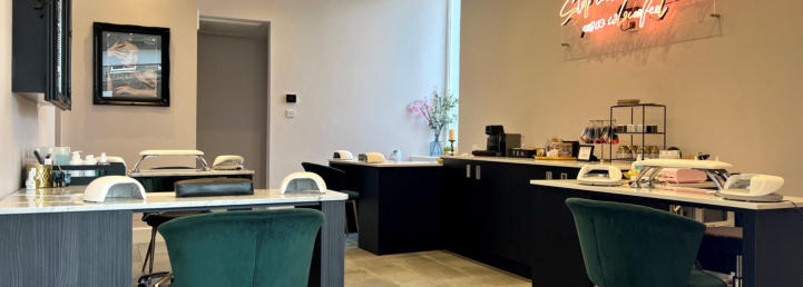 The nail bar, with manicure stations and green velvet chairs